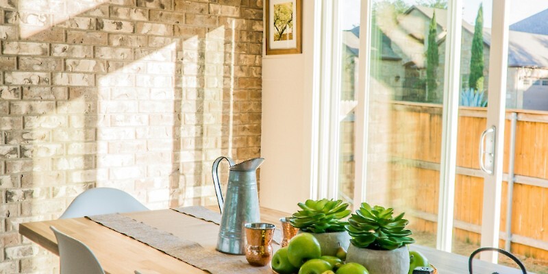 Black Kettle Beside Condiment Shakers and Green Fruits and Plants on Tray on Brown Wooden Table